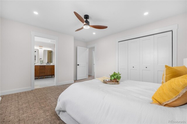 bedroom with baseboards, a closet, recessed lighting, carpet, and ensuite bath
