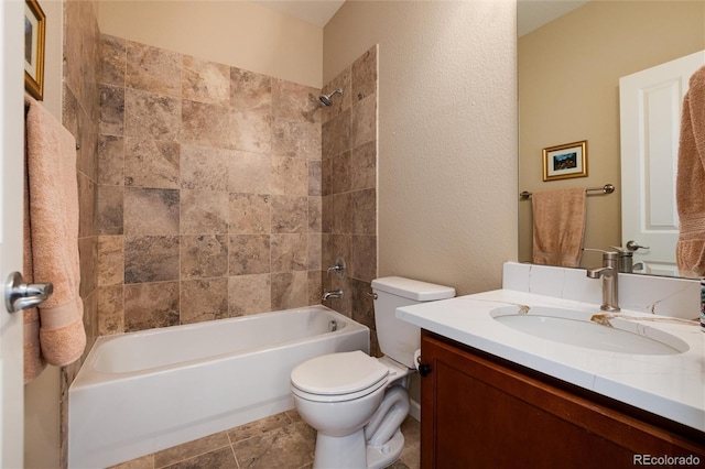 full bathroom featuring vanity, toilet, and tiled shower / bath