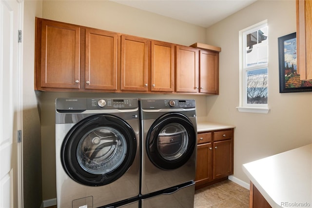 laundry area featuring cabinets and washer and clothes dryer