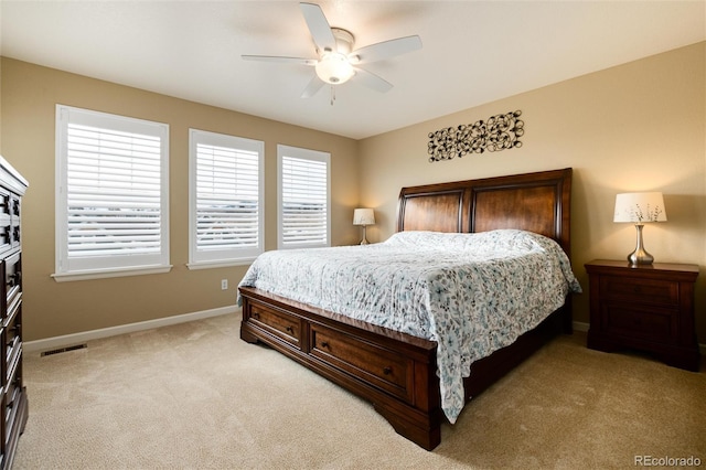 bedroom with light carpet and ceiling fan