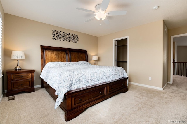 carpeted bedroom with ceiling fan, a spacious closet, and a closet