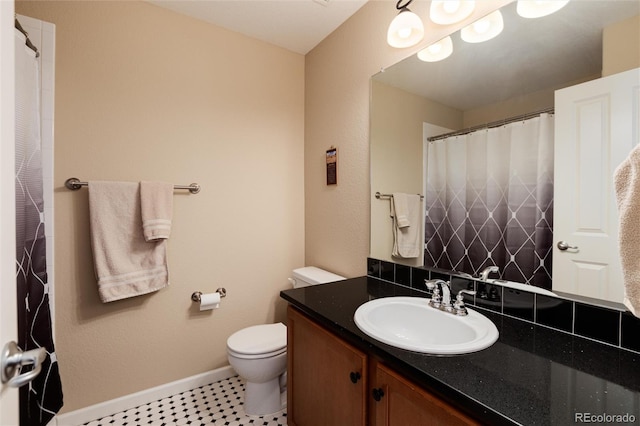 bathroom featuring tile patterned flooring, vanity, and toilet