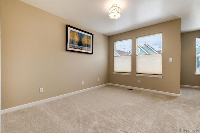 empty room featuring light carpet