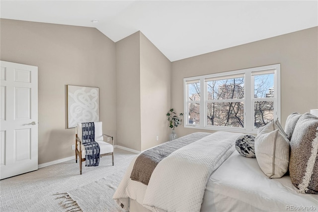 carpeted bedroom featuring vaulted ceiling