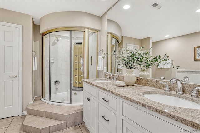 bathroom with tile patterned floors, vanity, and an enclosed shower