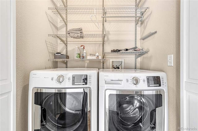 clothes washing area featuring washer and clothes dryer