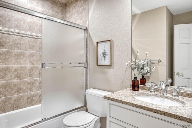 full bathroom featuring vanity, toilet, and bath / shower combo with glass door