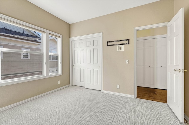 unfurnished bedroom featuring light carpet