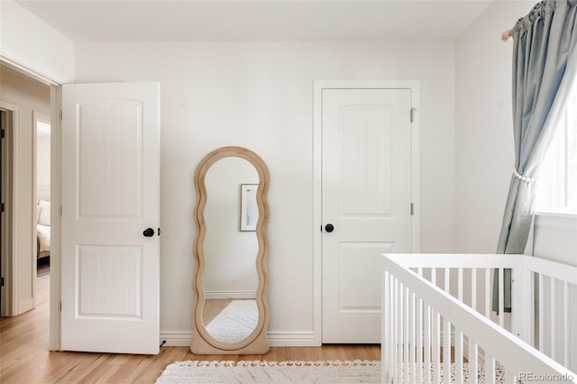 2263 Yellowstone St, Golden, CO 80401 - bedroom with light wood finished floors and a crib