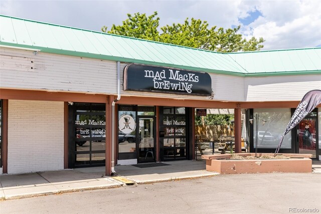 2263 Yellowstone St, Golden, CO 80401 - property entrance featuring brick siding and a metal roof