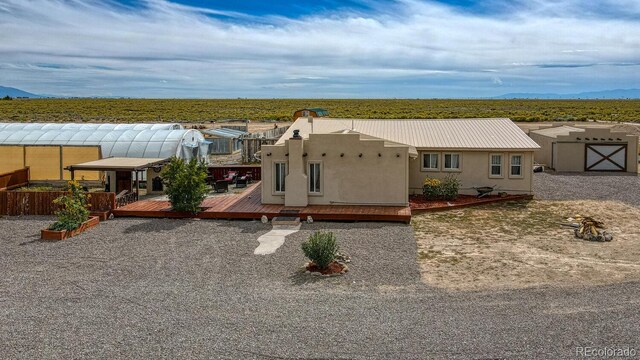 56506 County Road Aa, Moffat, CO 81143 - view of front of home featuring a deck with mountain view and stucco siding
