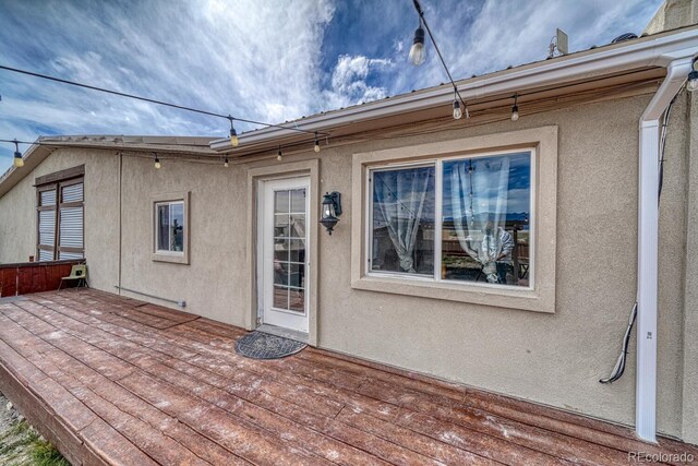 56506 County Road Aa, Moffat, CO 81143 - rear view of house featuring a deck and stucco siding
