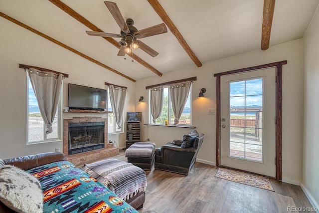 56506 County Road Aa, Moffat, CO 81143 - living room featuring a tiled fireplace, wood finished floors, a ceiling fan, and baseboards