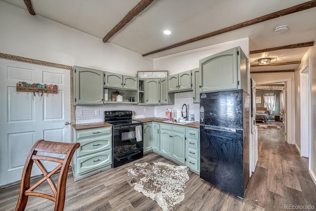 56506 County Road Aa, Moffat, CO 81143 - kitchen featuring green cabinetry, black appliances, a sink, backsplash, and beam ceiling