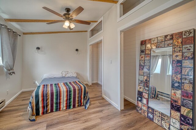 56506 County Road Aa, Moffat, CO 81143 - bedroom with a baseboard heating unit, wood finished floors, baseboards, ceiling fan, and beam ceiling