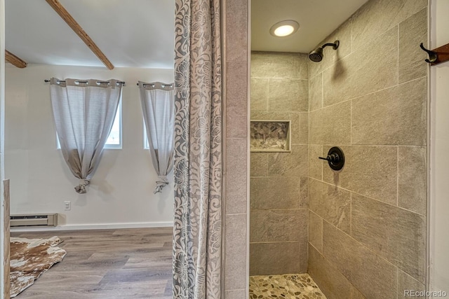 56506 County Road Aa, Moffat, CO 81143 - bathroom with tiled shower, wood finished floors, and baseboard heating