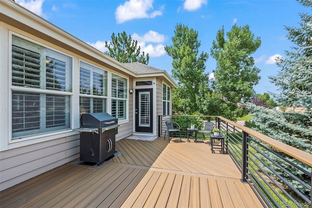 wooden terrace featuring a grill