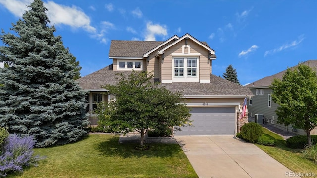 view of front of property with a garage, a front lawn, and central air condition unit