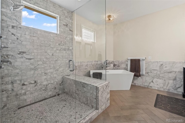 bathroom with separate shower and tub and tile walls