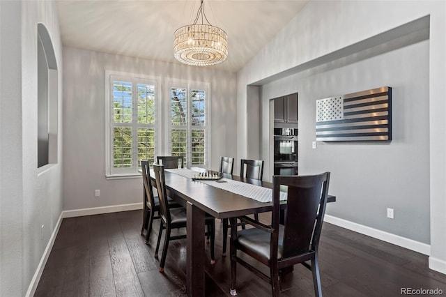 dining room featuring a chandelier, dark hardwood / wood-style flooring, and vaulted ceiling