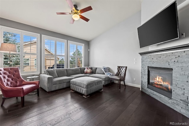 living room with dark hardwood / wood-style flooring, ceiling fan, a fireplace, and a healthy amount of sunlight