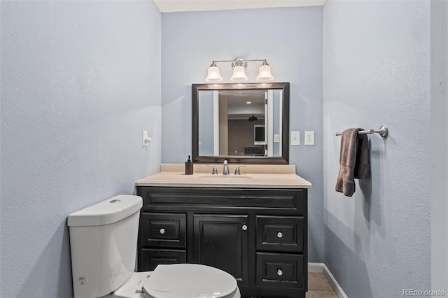 bathroom with tile patterned floors, vanity, and toilet