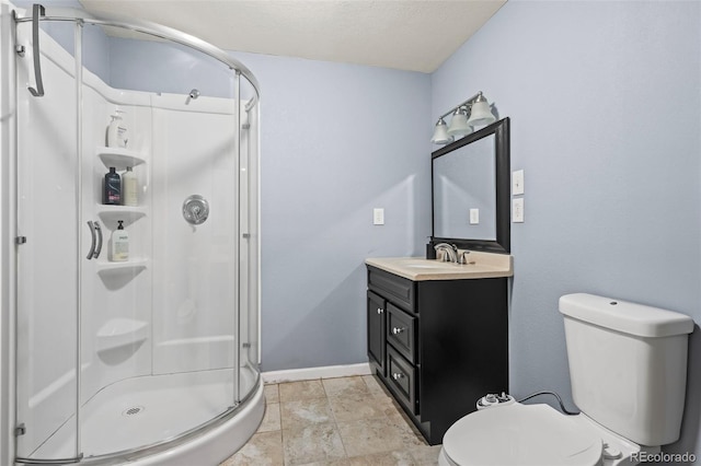 bathroom with a shower with door, vanity, and toilet