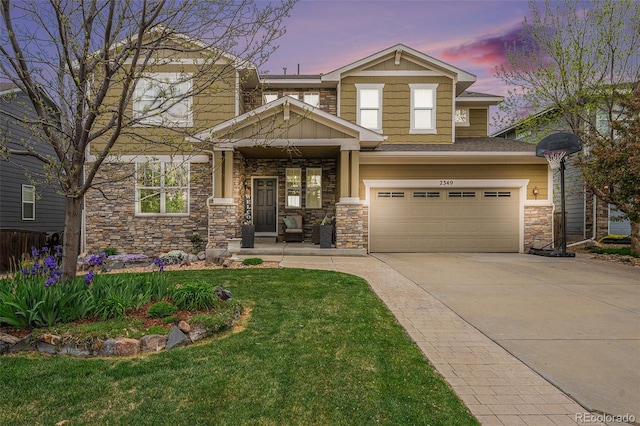 2349 Hickory Pl, Erie, CO 80516 - view of front of property with a garage, driveway, a front lawn, and stone siding