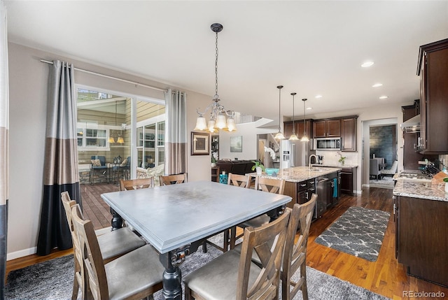 2349 Hickory Pl, Erie, CO 80516 - dining space with recessed lighting, baseboards, dark wood-style floors, and a chandelier