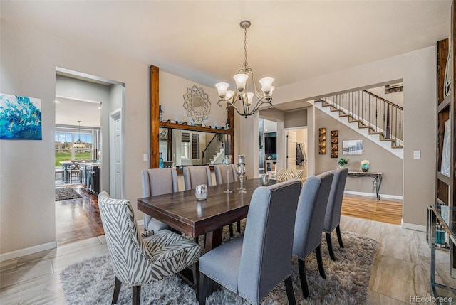 2349 Hickory Pl, Erie, CO 80516 - dining room with stairs, baseboards, and a notable chandelier