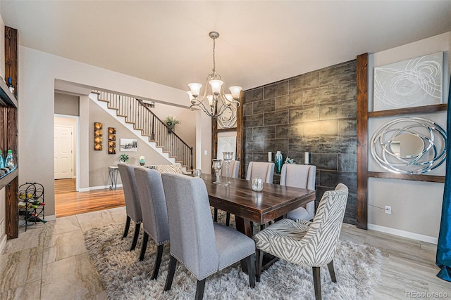 2349 Hickory Pl, Erie, CO 80516 - dining area featuring stairs, tile walls, baseboards, and a chandelier