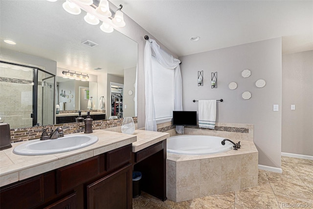 2349 Hickory Pl, Erie, CO 80516 - bathroom featuring a garden tub, decorative backsplash, visible vents, baseboards, and a shower stall