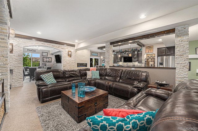 2349 Hickory Pl, Erie, CO 80516 - living area featuring carpet, decorative columns, arched walkways, and indoor bar