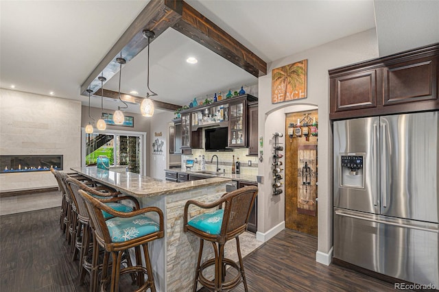 2349 Hickory Pl, Erie, CO 80516 - kitchen with dark wood-style flooring, dark brown cabinets, a sink, a kitchen breakfast bar, and stainless steel refrigerator with ice dispenser