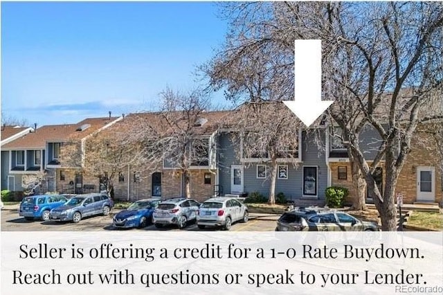 8773 W Cornell Ave Unit 10, Lakewood, CO 80227 - view of front of house featuring a chimney and uncovered parking