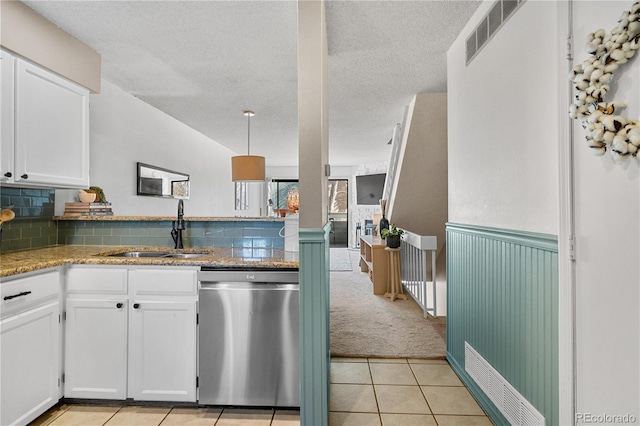 8773 W Cornell Ave Unit 10, Lakewood, CO 80227 - kitchen featuring stainless steel dishwasher, a sink, white cabinets, a textured ceiling, and light tile patterned floors