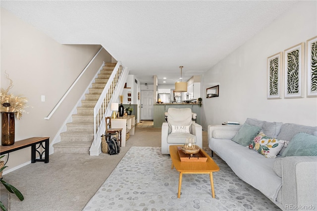8773 W Cornell Ave Unit 10, Lakewood, CO 80227 - living area with light carpet, stairway, a textured ceiling, and baseboards