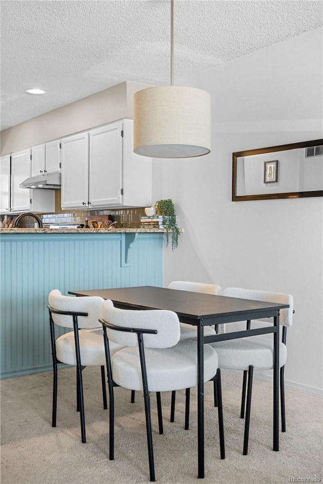 8773 W Cornell Ave Unit 10, Lakewood, CO 80227 - dining area with light colored carpet and a textured ceiling