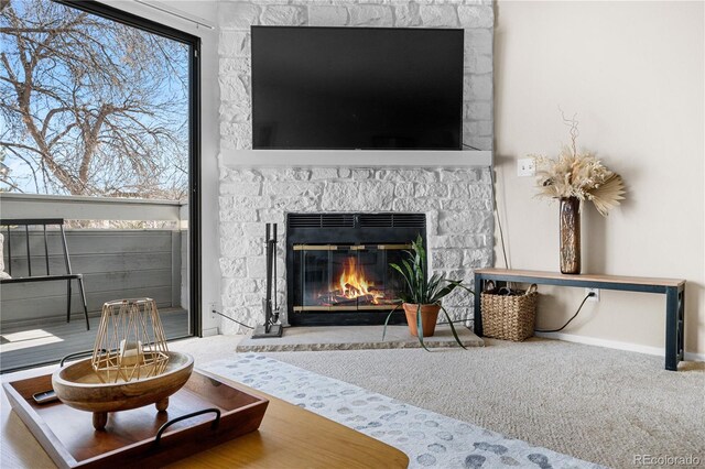 8773 W Cornell Ave Unit 10, Lakewood, CO 80227 - living area featuring a fireplace and baseboards