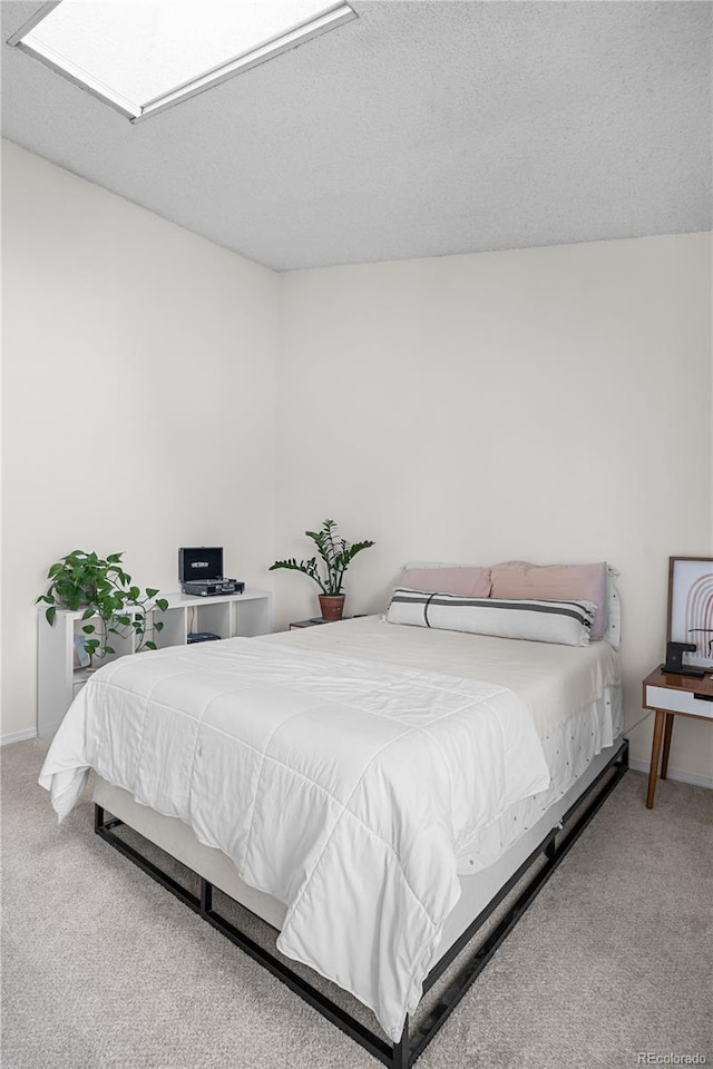 8773 W Cornell Ave Unit 10, Lakewood, CO 80227 - bedroom with carpet, a skylight, and a textured ceiling