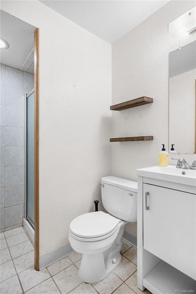 8773 W Cornell Ave Unit 10, Lakewood, CO 80227 - bathroom featuring toilet, a shower stall, and vanity