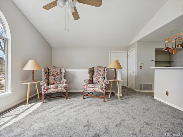 living area featuring vaulted ceiling, carpet floors, a ceiling fan, and baseboards