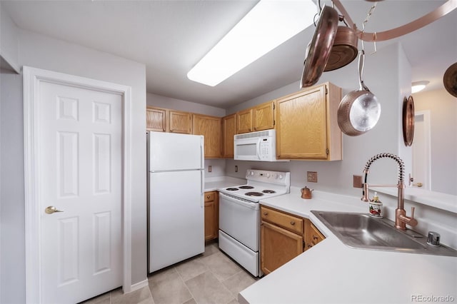 8621 E Dry Creek Rd Unit 325, Englewood, CO 80112 - kitchen with white appliances, a sink, light countertops, and light tile patterned floors
