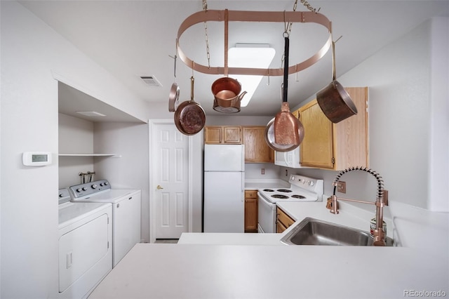 8621 E Dry Creek Rd Unit 325, Englewood, CO 80112 - kitchen with white appliances, washer and clothes dryer, a sink, and light countertops