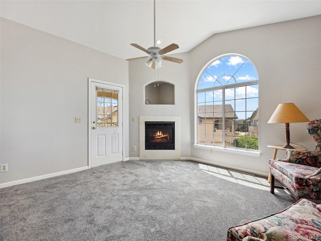 8621 E Dry Creek Rd Unit 325, Englewood, CO 80112 - living room with carpet flooring, ceiling fan, a warm lit fireplace, baseboards, and high vaulted ceiling