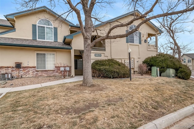 8621 E Dry Creek Rd Unit 325, Englewood, CO 80112 - view of front facade featuring stucco siding and brick siding