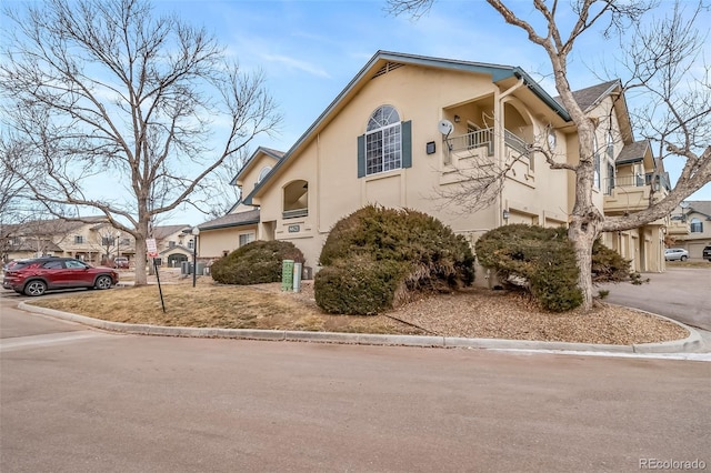 8621 E Dry Creek Rd Unit 325, Englewood, CO 80112 - view of front of property with stucco siding, a balcony, and a residential view