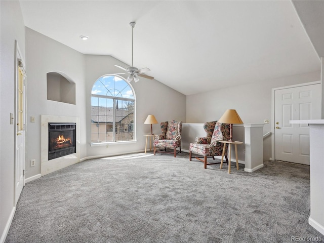 8621 E Dry Creek Rd Unit 325, Englewood, CO 80112 - living area featuring carpet floors, vaulted ceiling, a glass covered fireplace, baseboards, and ceiling fan