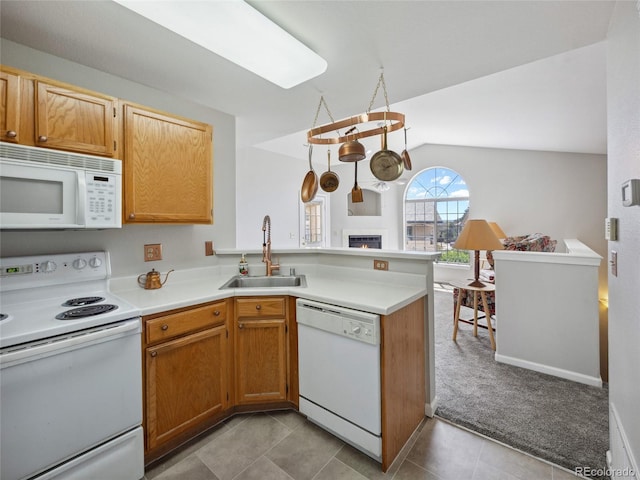 8621 E Dry Creek Rd Unit 325, Englewood, CO 80112 - kitchen featuring white appliances, a sink, a peninsula, vaulted ceiling, and light countertops