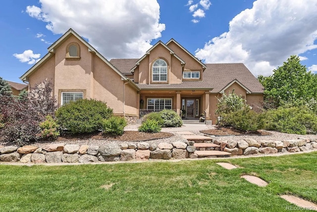 traditional-style home with a front lawn and stucco siding